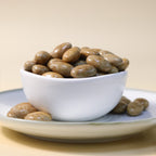 Yathrib Premium Caramel Almond Dragee showing glossy caramel-coated almonds on a white background