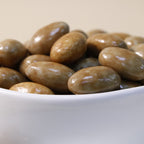 Yathrib Premium Caramel Almond Dragee showing glossy caramel-coated almonds arranged in a close-up shot