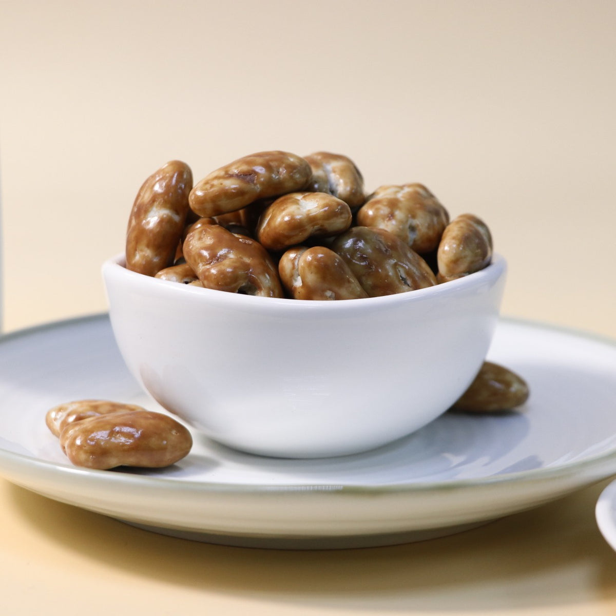 Yathrib caramel pecan dragee with glossy caramel coating and crunchy pecans in a close-up shot.