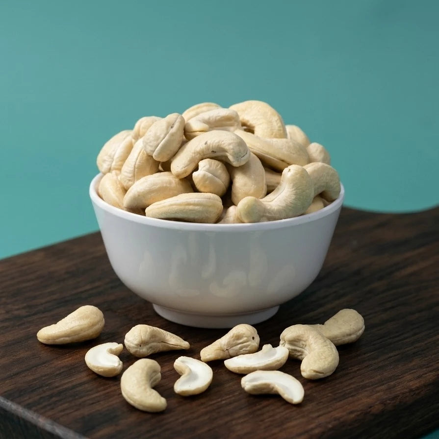Yathrib Premium Plain Cashews W240 in a bowl, showing large, roasted cashew nuts with smooth, light golden surface.