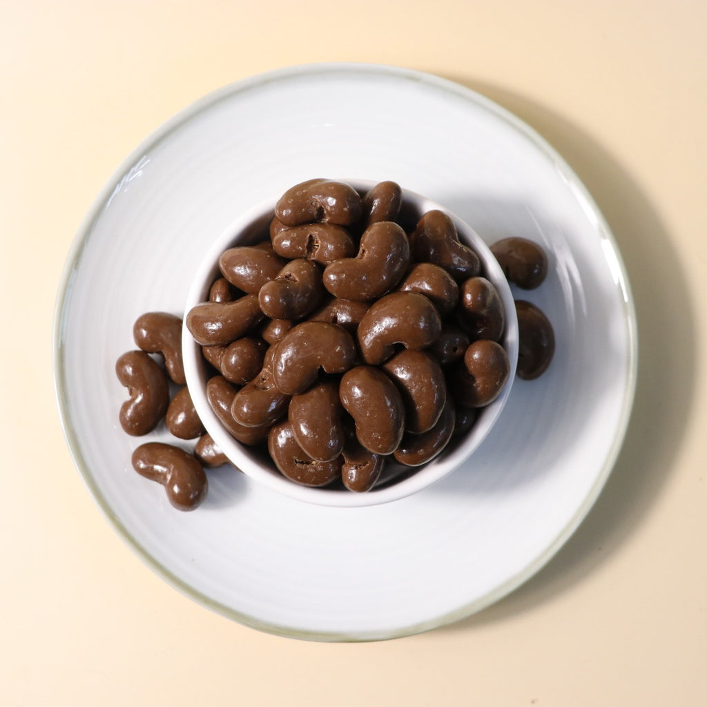 Yathrib Classic Chocolate Cashew Dragee showing glossy chocolate-coated cashews in a clear bowl