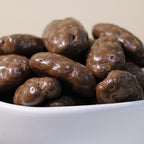 Yathrib Rich Chocolate Pecan Dragee showing glossy chocolate-coated pecan candies on a white background