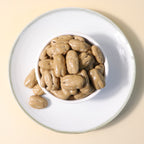 Yathrib Coffee Pecan Dragee close-up showing shiny glazed pecans coated in coffee-flavored candy shell.
