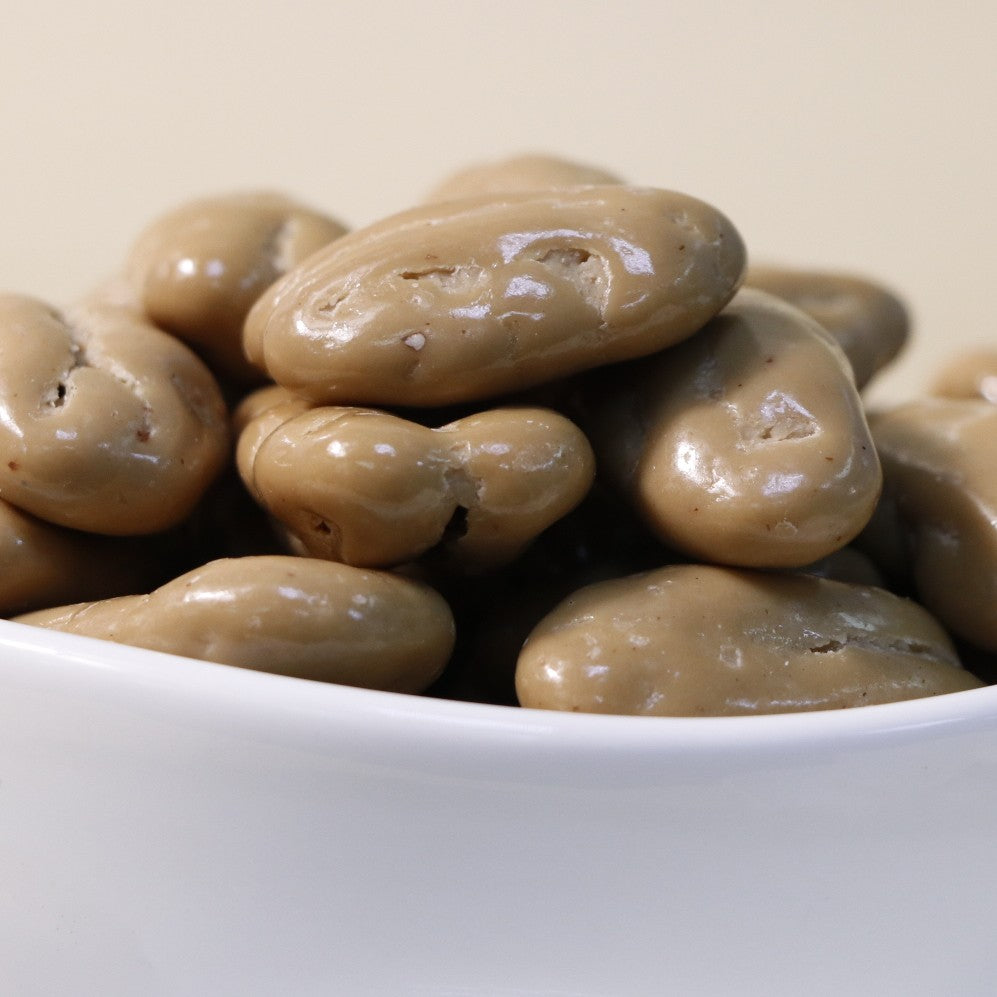 Yathrib Coffee Pecan Dragee close-up showing glossy coated pecans with coffee-flavored coating on a white background