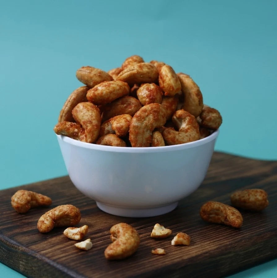Yathrib savory cheese roasted cashews in a bowl, showing golden-brown nuts coated with cheese seasoning.