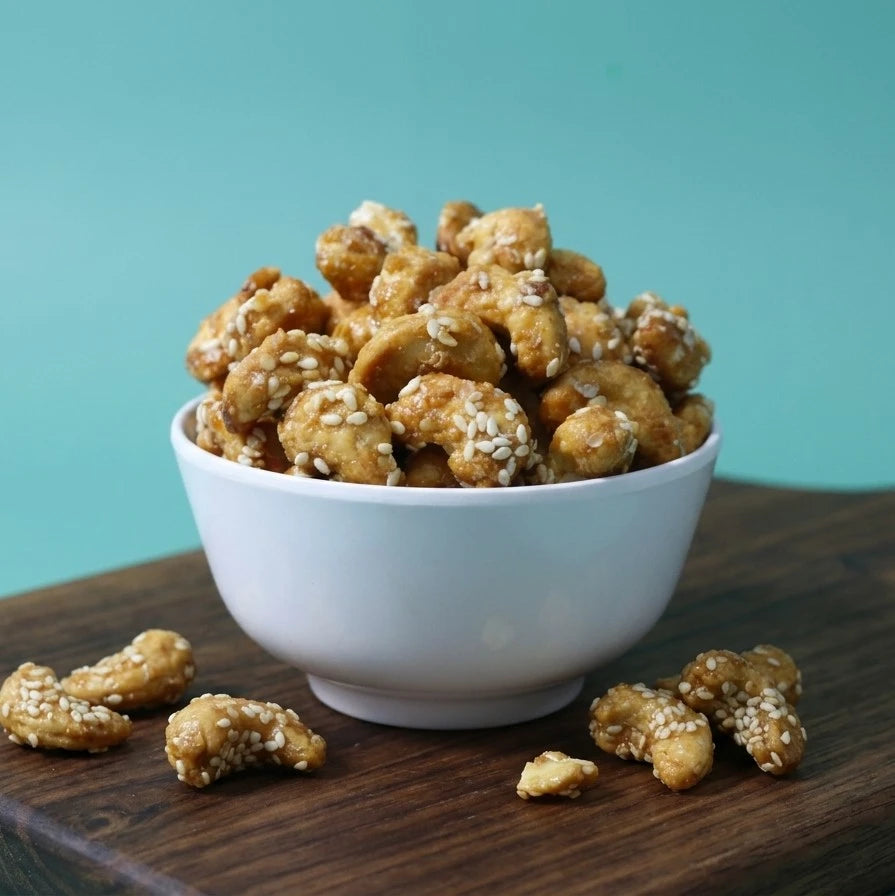 Yathrib Sweet Honey Roasted Cashews in a bowl, showcasing golden, glazed cashew nuts with honey coating.