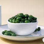 Yathrib Premium Matcha Pistachio Dragee with green matcha coating and crushed pistachio filling on a white background.