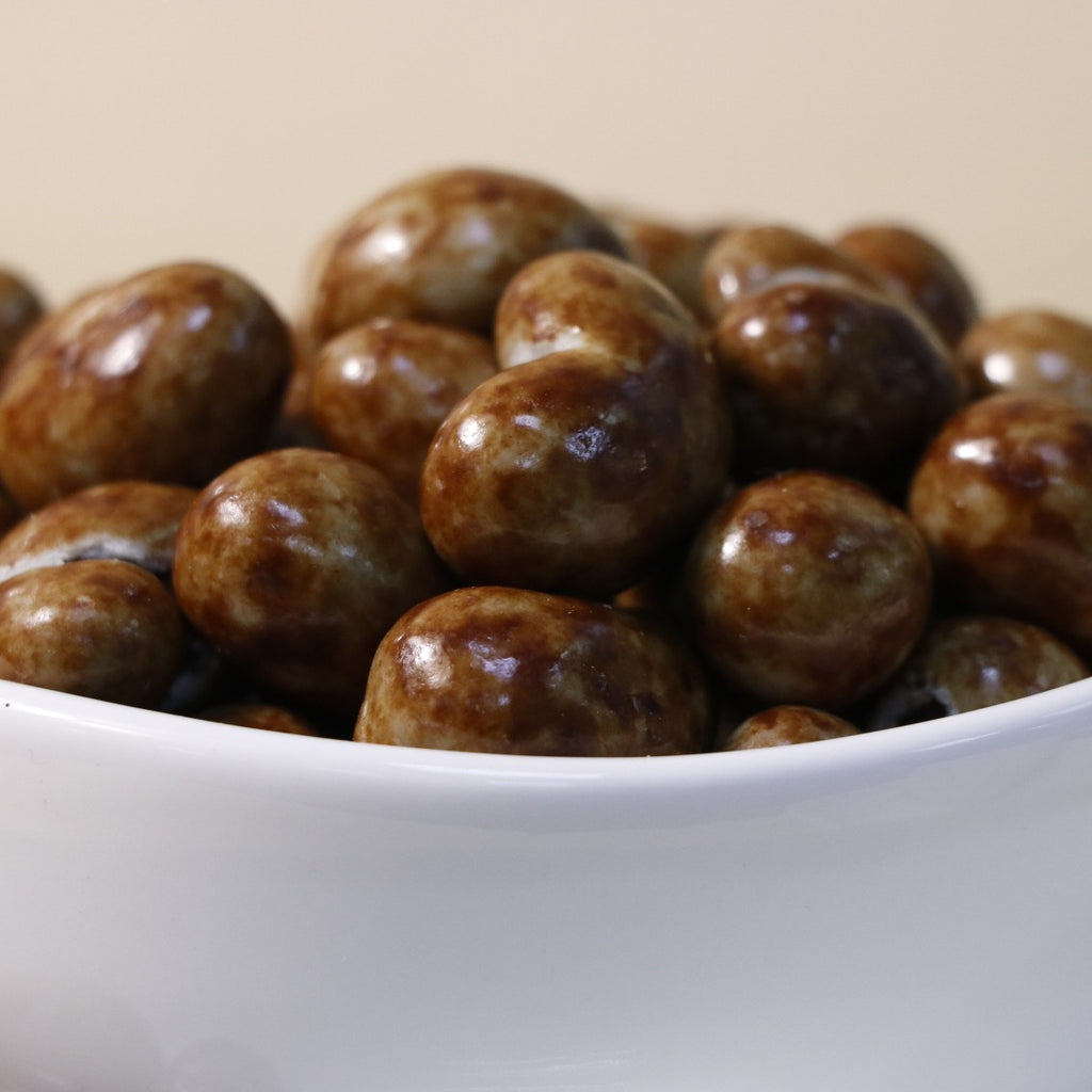 Yathrib classic milk chocolate cashew dragee showing glossy milk chocolate coating and crunchy cashew nuts inside.