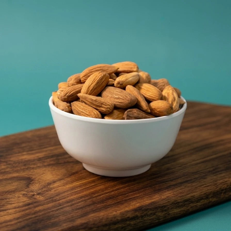 Yathrib Premium Mamra Almonds from Uzbekistan in a bowl, showcasing golden, crunchy almonds with textured shells.