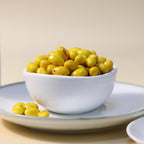 Yathrib saffron pistachio dragee with golden coating and visible pistachio nuts, showcasing a luxurious confectionery treat.
