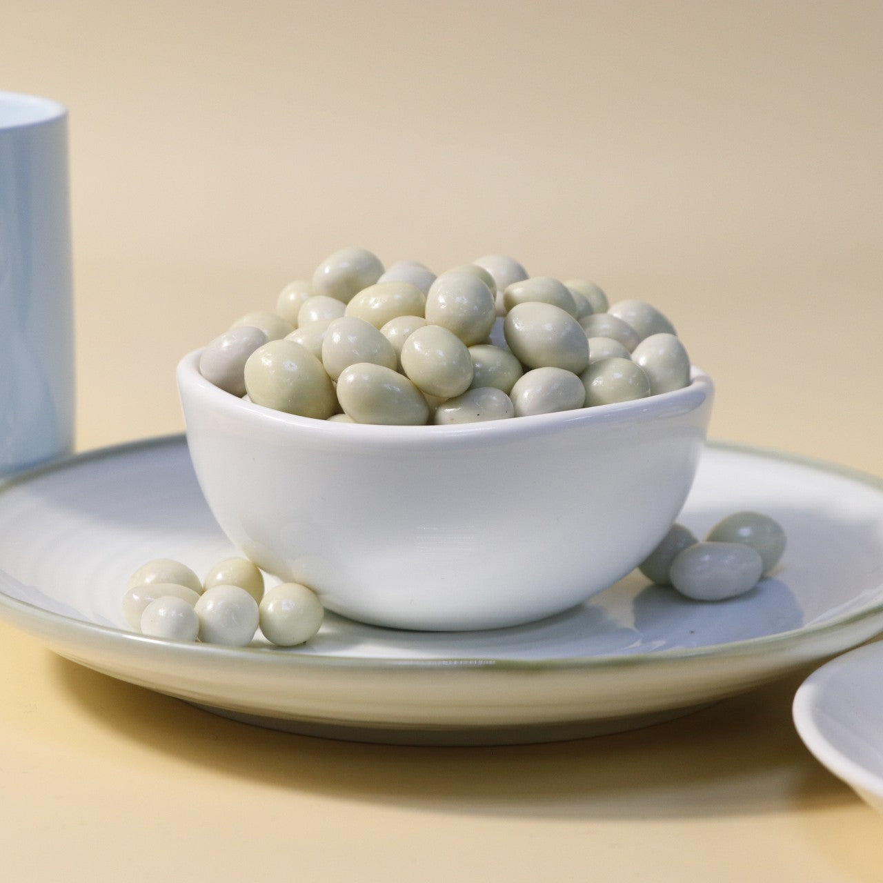 Yathrib white chocolate pistachio dragee with creamy white chocolate coating and green pistachio nuts inside.