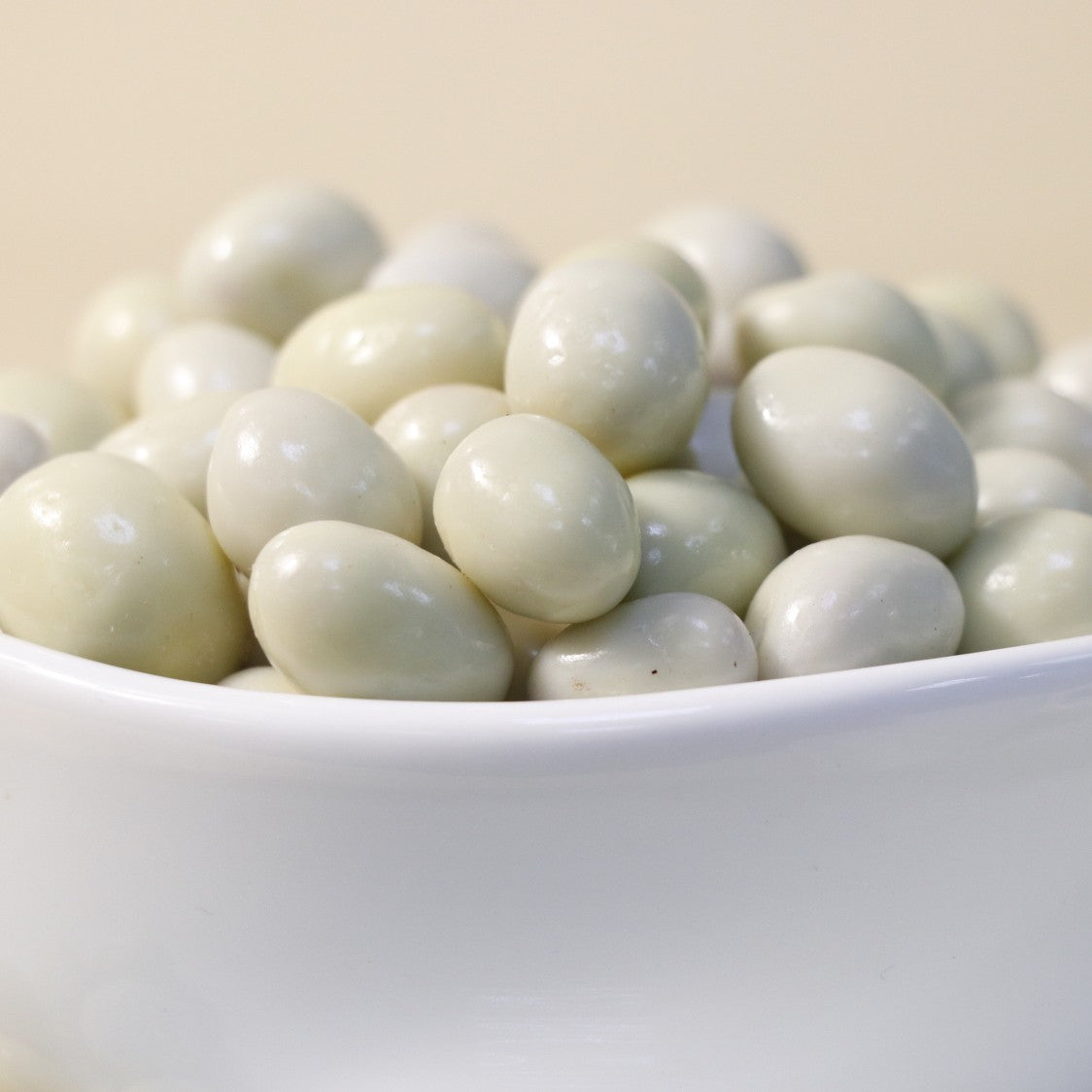 Yathrib white chocolate pistachio dragee featuring a glossy white chocolate coating and crunchy pistachio center.