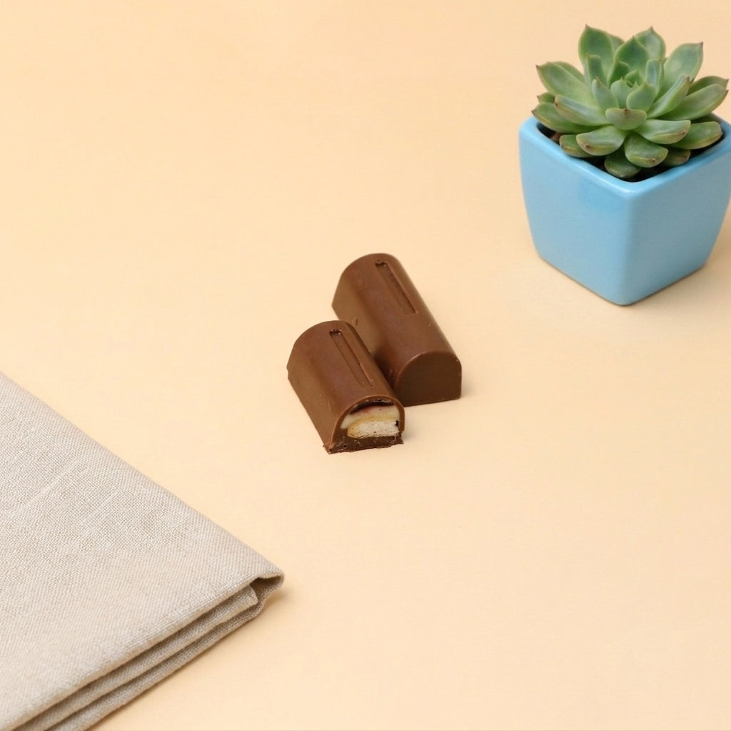 Yathrib Biscocello biscuit jelly chocolate in a wrapper, showcasing the sweet, layered biscuit and chocolate filling inside.
