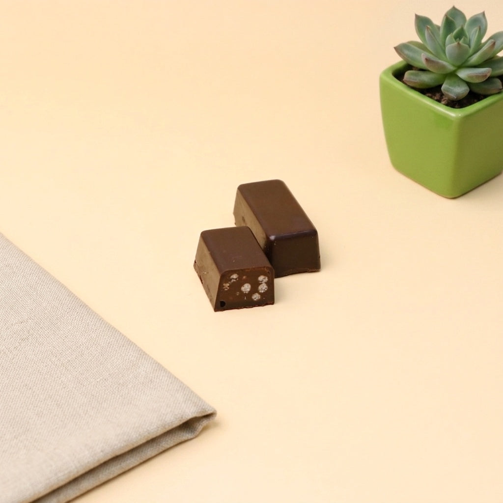 Yathrib Nerocanto crispy dark chocolate bar with textured surface and rich, dark cocoa flavor in a sleek packaging.